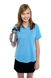 Teen in sports wear posing with a water bottle