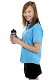 Girl holding sipper bottle. Break from gym workout