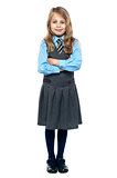 Confident school girl in pinafore uniform