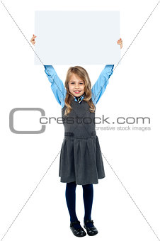 Kid holding blank billboard above her head