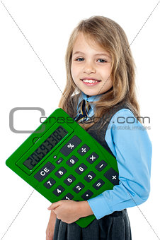 Cheerful kid holding big green calculator