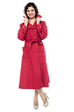 Portrait of a trendy woman in maroon overcoat