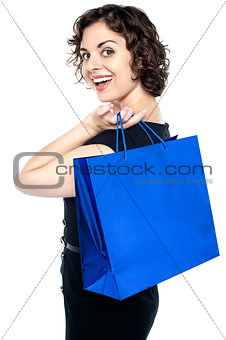 Joyous woman posing with a shopping bag
