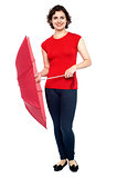 Stylish young woman with an umbrella in hand