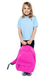 Little schoolgirl posing with pink backpack