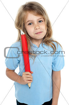 Straight faced kid holding huge red pencil
