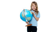 Smart young girl showing her country on a globe