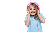 Excited girl enjoying music through headphones