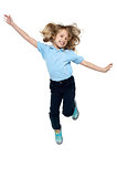 Energetic young child jumping high