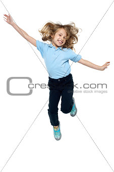 Energetic young child jumping high
