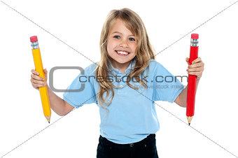 Innocent child posing with colorful pencils