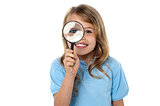 Smiling kid with magnifying glass