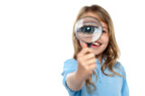 Young girl playing around with magnifying glass