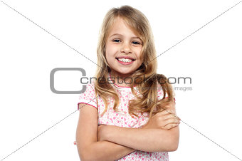 Cute young girl posing with hands crossed