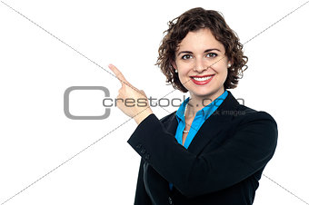 Smiling business professional pointing away
