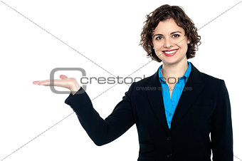 Smiling woman posing with open palm