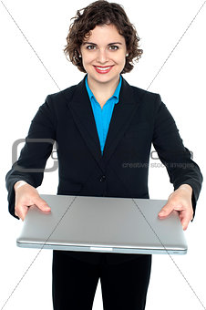 Pretty businesswoman presenting a laptop