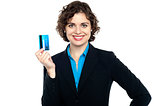 Smiling corporate woman holding credit card