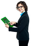 Cheerful executive using big green calculator
