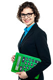 Side pose of a business lady holding calculator