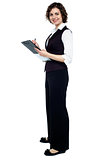 Charming business lady posing with a clipboard