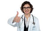 Successful young doctor showing thumbs up