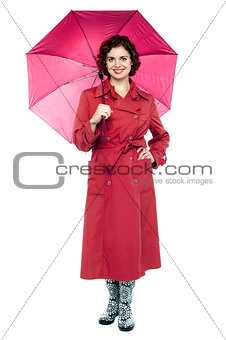 Fashionable young woman in maroon overcoat