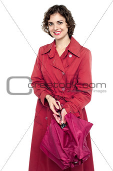 Smiling lady opening umbrella before moving out