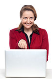 Female business executive pointing at laptop