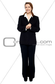Cheerful business professional with hands clasped