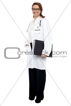 Smiling lady doctor with medical file in hand