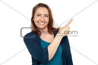 Joyous smart woman pointing away