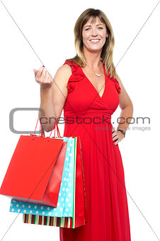 Elegant shopaholic woman carrying shopping bags