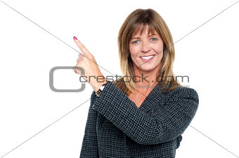 Confident corporate lady pointing away