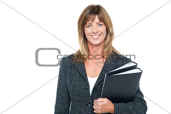 Cheerful secretary holding business files