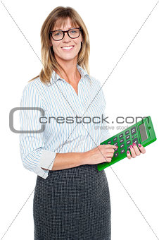 Bespectacled entrepreneur holding calculator