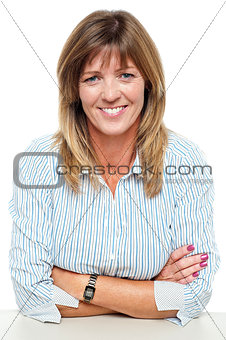 Smiling middle aged executive with folded arms