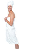 Gorgeous female in bath towel posing sideways
