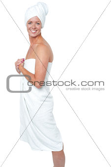 Gorgeous female in bath towel posing sideways