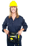 Confident female worker in yellow helmet