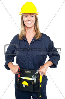 Confident female worker in yellow helmet