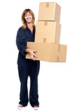 Smiling woman with stack of cardboard boxes