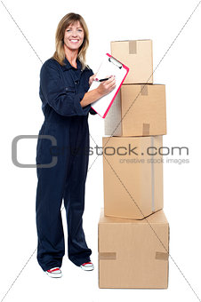 Happy delivery woman preparing an invoice