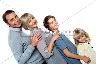 Cheerful family of four leaning backwards