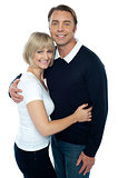 Stylish man in pullover embracing his blonde wife