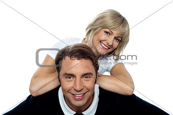 Beautiful wife leaning over her cheerful husband