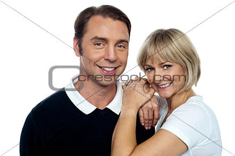 Adorable wife cuddling up her handsome husband