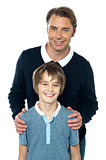 Man in blue pullover posing with his son