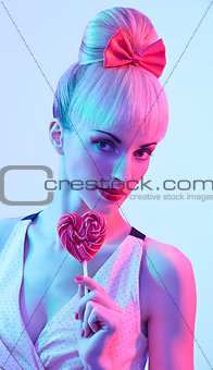 Fashion girl portrait with Heart shaped big lollipop