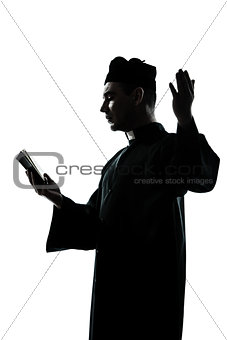 man priest silhouette reading bible